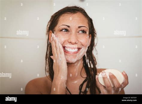 Beautiful Young Smiling Woman Washing Her Face With Soap In The