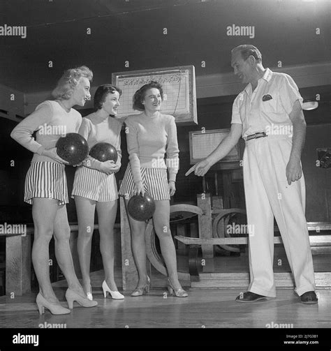 Bowling In The 1950s A Man With Three Young Women In A Bowling Alley
