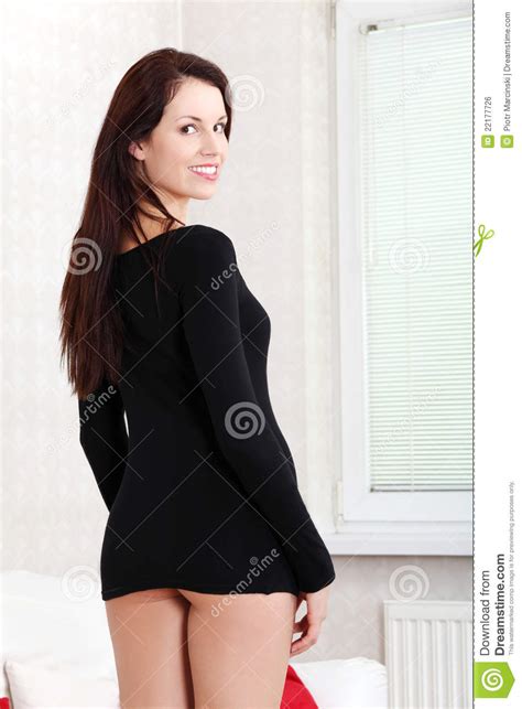 a half naked woman standing in the living room stock