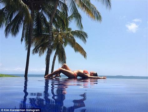 kim kardashian reclines poolside in bikini as she prepares to leave mexico resort daily mail