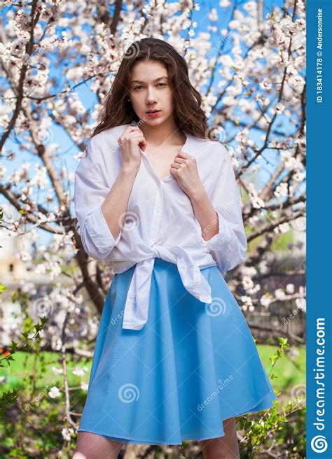 Pretty Teen Girl Are Posing In Garden Near Blossom Cherry