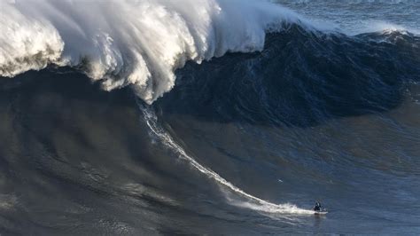 giant wave slams  british surfer andrew cotton causing huge wipeout
