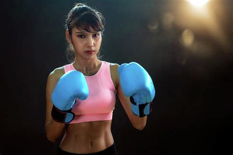 Asian Girl In Boxing Action With Black Background And Light Photograph