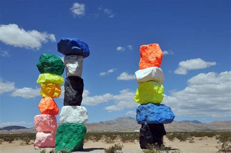 fluorescent colored boulders art piece called  magic mountains