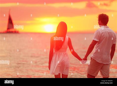 Honeymoon Couple Romantic In Love Holding Hands At Beach Sunset