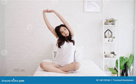 Beautiful Asian Woman Stretching Her Body After She Wake Up In Her