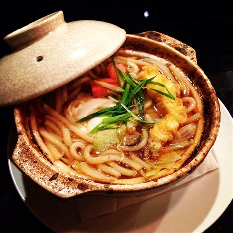 nabeyaki udon noodle soup  chicken egg shrimp tempura  vegetables cooked