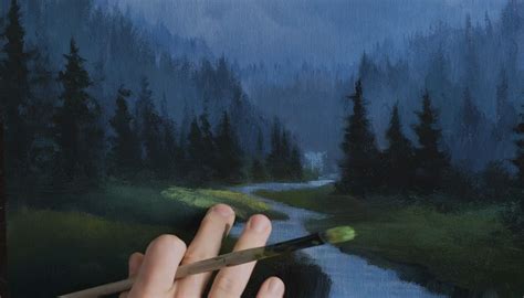 person  holding  paintbrush   hand  painting  landscape