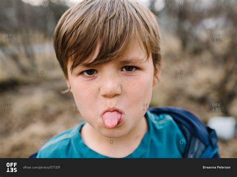 young boy sticking   tongue stock photo offset