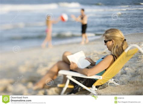 Mom Reading In Lounge Chair On Beach Stock Image Image