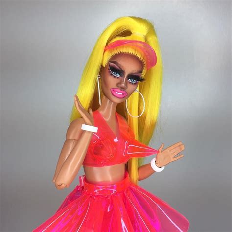 barbie doll  bright yellow hair  pink dress holding  hand
