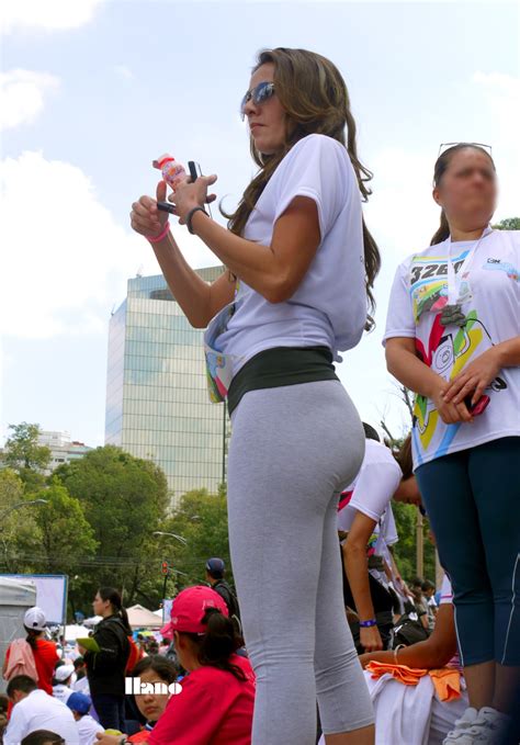 pretty brunette in tight gray leggings showing round ass