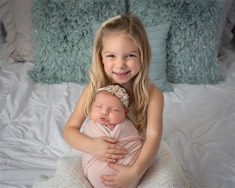 sister newborn photographs  big happy photo