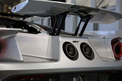 rear    silver sports car  speakers   trunk  hood
