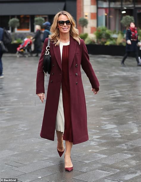 amanda holden oozes elegance in a chic burgundy coat while