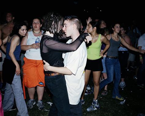A Man And Woman Dancing In Front Of A Group Of People At An Outdoor Party