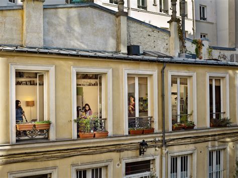voyeuristic photos capture intimate scenes through apartment windows in