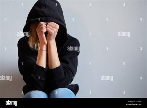 young girl hiding  face  hooded sweatshirt isolated  background stock photo alamy