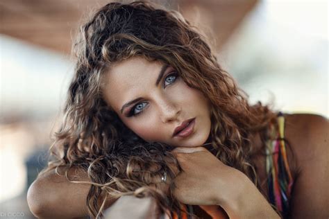 Download Tanned Woman With Curly Hair Wallpaper