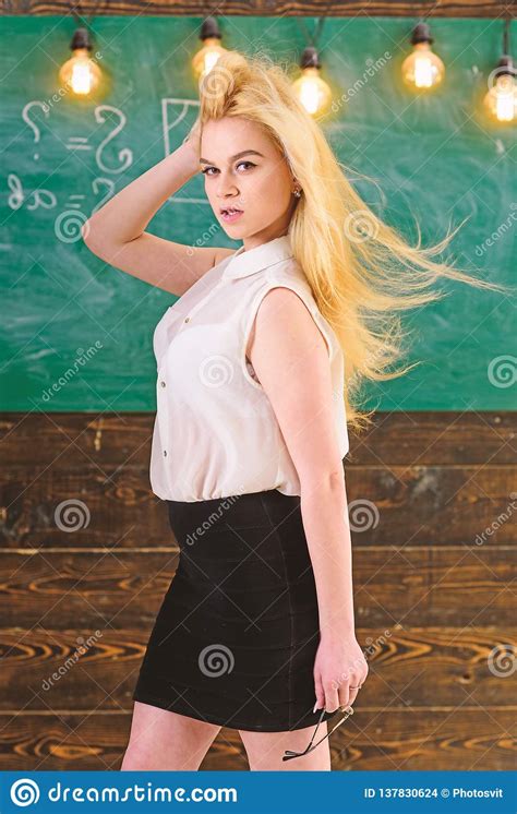 teacher with waving long blonde hair looks sexy lady strict teacher on