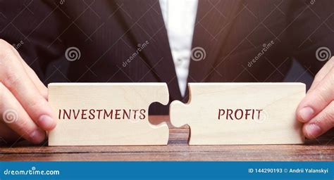 businessman collects puzzles   words investments  profit return  investment