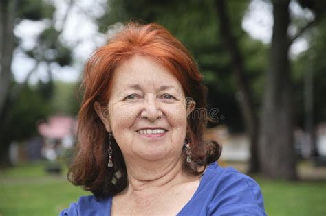 Mature Woman Smiling And Looking Slightly Upward In A Positive Attitude