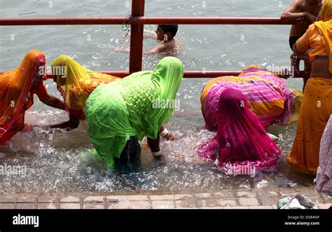 women bathing in the ganges river at the third shahi snan kumbh mela