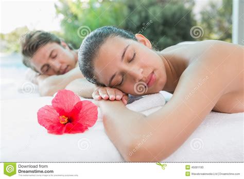 couple lying on massage table at spa center stock image