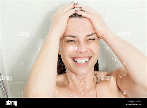 shower woman happy smiling woman washing shoulder showering in stock