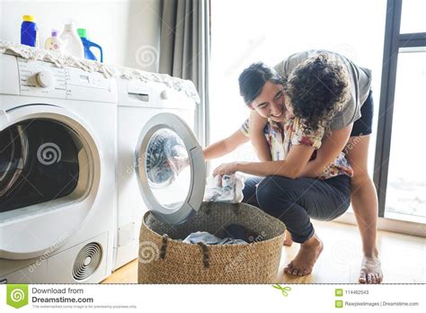 Lesbian Couple Doing Laundry Together Stock Image Image Of Lgbtq