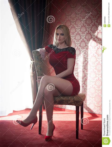 Attractive And Blonde Woman With Red Short Tight Fit Dress