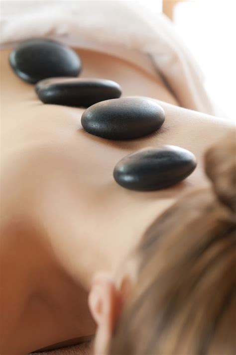 fight cold weather with hot stone massage wellness news