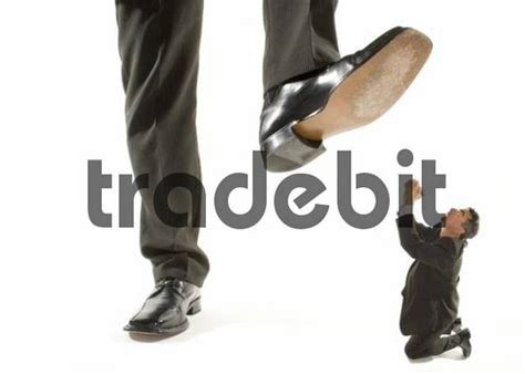 Giant Foot Stepping On A Kneeling Businessman Praying For