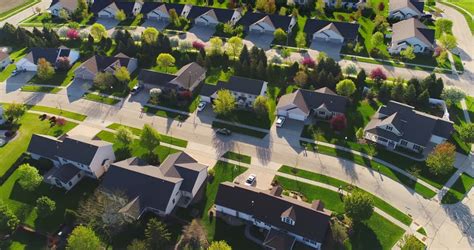beautiful suburbs  stunning houses  landscaped yards early morning aerial view stock