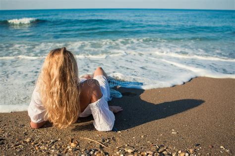 Blonde Lying On The Beach And See To The Ocean Stock Image