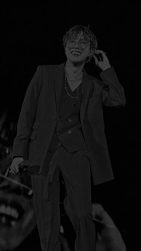 A Man In A Suit And Tie Walking On Stage