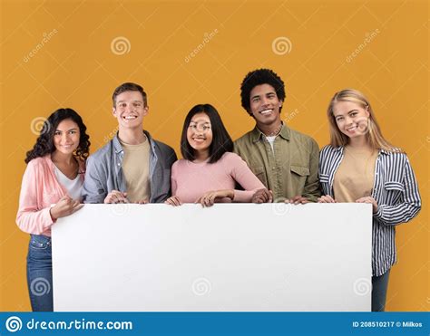 diverse teens cheerful international students holding big banner