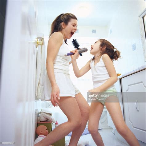 mother and daughter dancing and singing in bathroom photo getty images