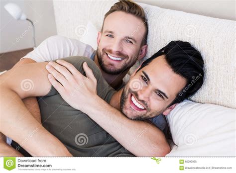 happy gay couple lying on bed stock image image of duvet cheerful