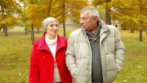 retired husband and wife walking and talking in the open air stock footage video 4961522