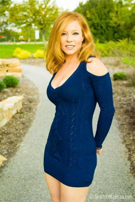 a woman in a blue dress is posing for a photo on a path with trees and