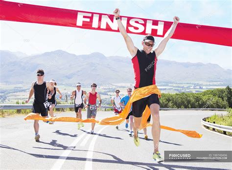 runner crossing race finish  people success stock photo
