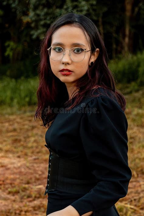 Young Caucasian Dark Haired Girl With Red Streaks In Black Dress Outfit