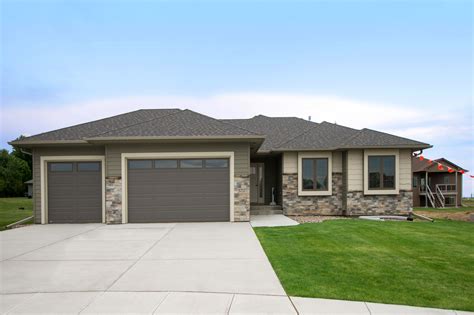 traditional ranch style exterior elevation includes stone facade garage doors  windows