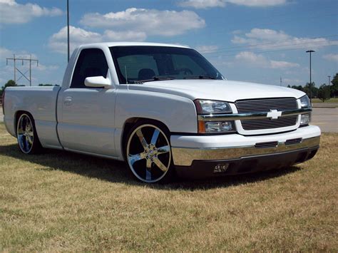 silver truck parked  top   grass covered field