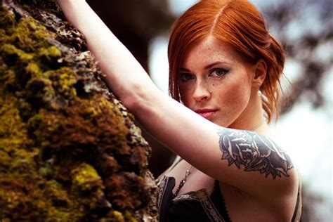 Woman With Flower Arm Tattoo Standing Next To Rock Hd