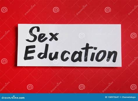 piece of paper with phrase `sex education` on red background stock