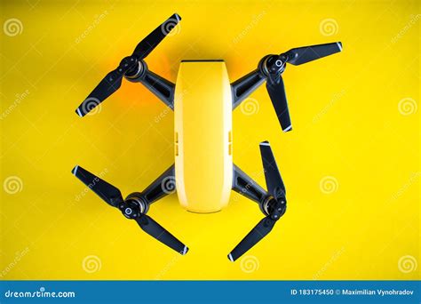 yellow drone   yellow background small pocket drone stock photo image  propeller high