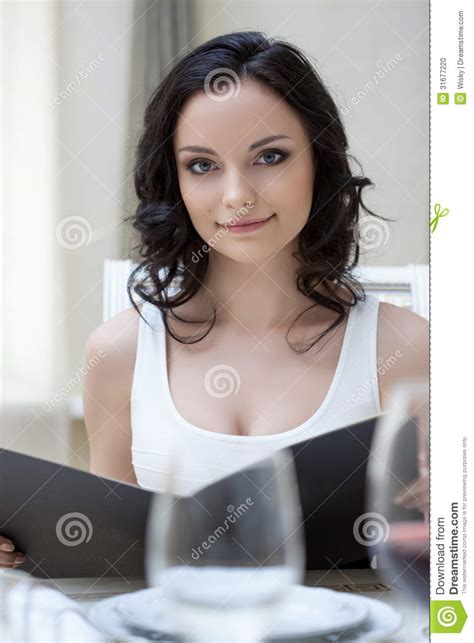 Portrait Of Cute Slim Brunette Posing With Menu Stock