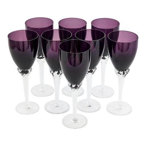 Six Purple Wine Glasses Are Lined Up In A Row On A White Surface One